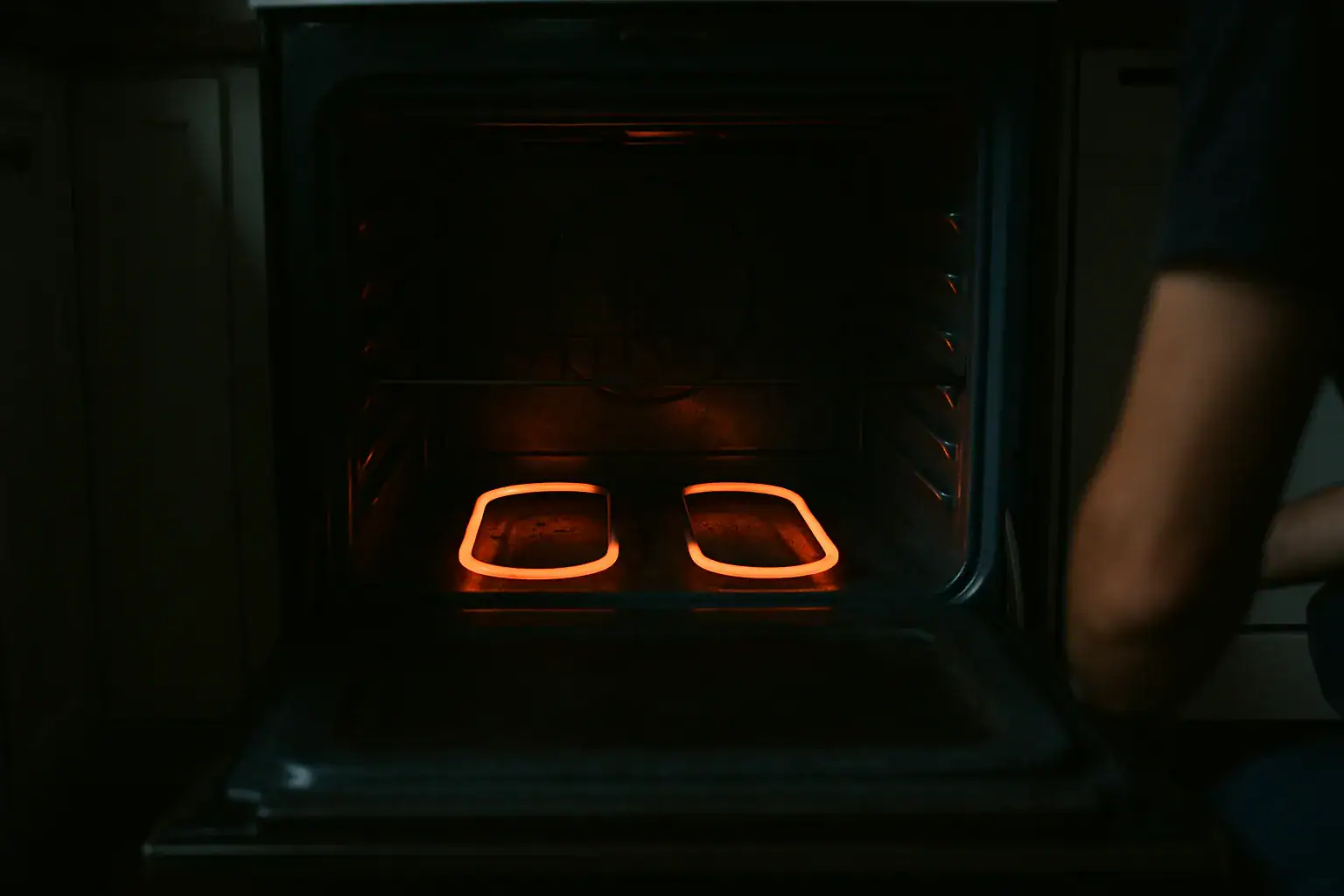 Electric oven bake element glowing evenly orange along its full length during a heating test